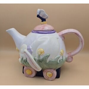 Teapot With Bunny Riding On A Wagon. And A Butterfly On The Teapot Lid.